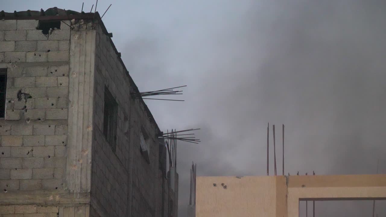 Smoke rising from recently bombed buildings in war-torn Gaza during the Hamas war conflict