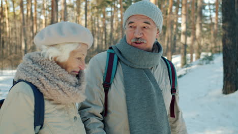 Senior Couple Hiking in a Snowy Forest
