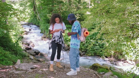 couple hiking by a river in the forest