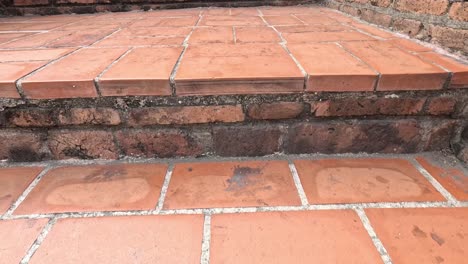 progressive frames of terracotta stairs being ascended