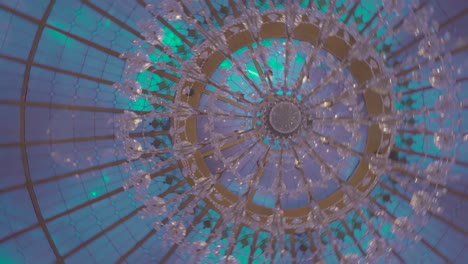 spinning image of an etheric multi colored glass chandelier in the celling of an event space