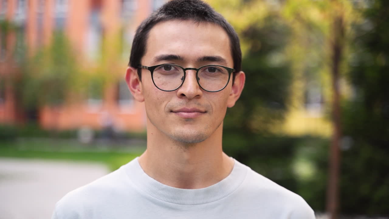 Outdoor Portrait Of A Young Japanese Man Wearing Eyeglasses Smiling And Looking At Camera 1