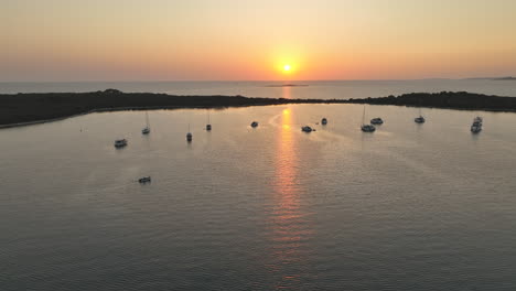 silhouette of luxury yachts with reflection of colourful sunset in croatia