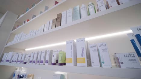 bottles of various shades concealer on display in the cosmetics section of a store