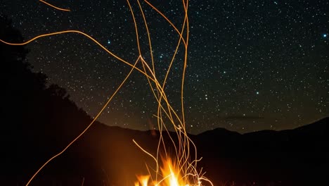 a mesmerizing display of a campfire dancing under a starlit sky, capturing the essence of a tranquil night in nature, where flames intertwine with celestial beauty