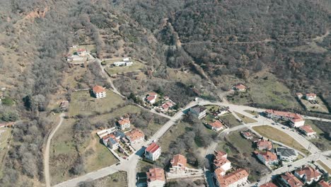 A-drone-shot-of-forest-mountain,-warm-weather,-flying-above-a-dreamy-village-hill,-4K-video,-European-winter-nature,-beautiful-landscape