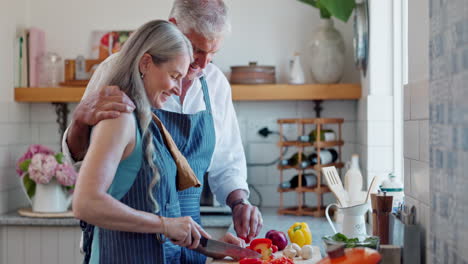 happy senior couple cooking together