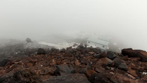 mountain summit hut in fog