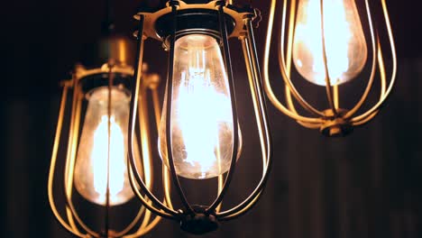 Three-Stylish-Light-Bulbs-in-Dark-Room-4K