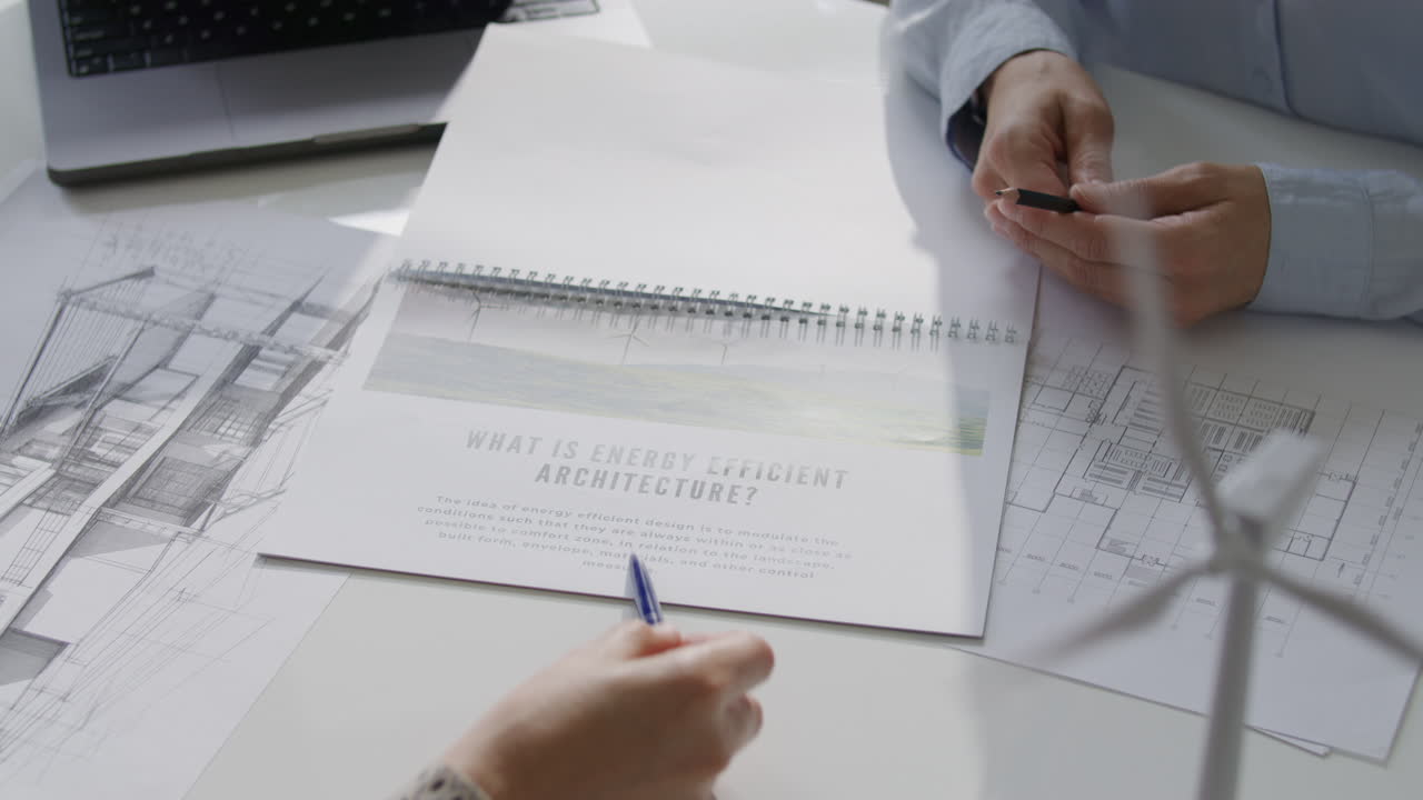 Close Up of Colleagues Discussing Energy Efficient Architecture Project