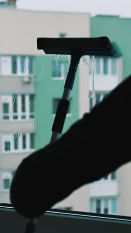 glass cleaning professioanl worker. window cleaning indoor interior. vertical video