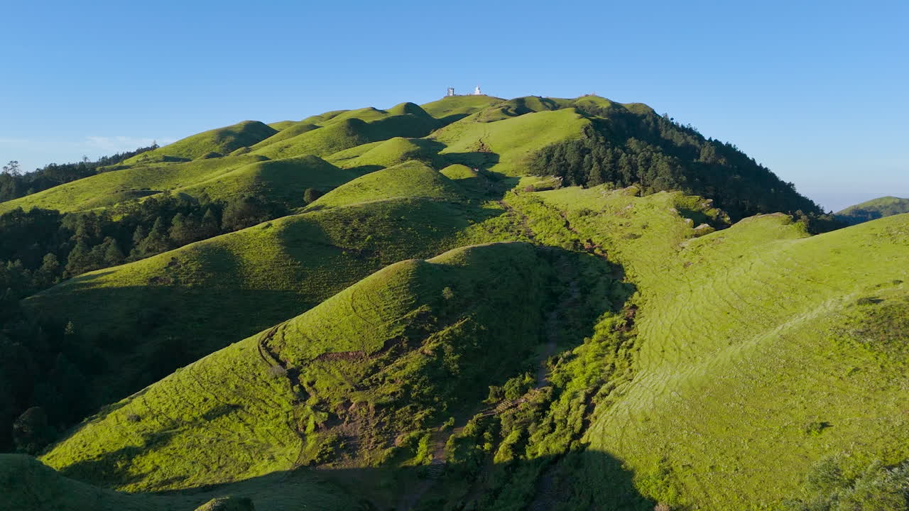 drone shot of Nepal's landscape greenery above the hills of Shailung Dolakha near Tibet under blue sky morning forest shins bright trekking trails lead to heavenly nature adventurous tourism