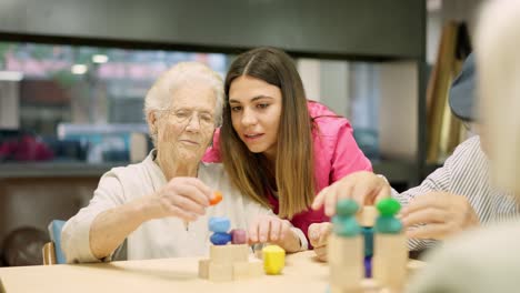 Seniors enjoying puzzle activity in a care facility with caregiver