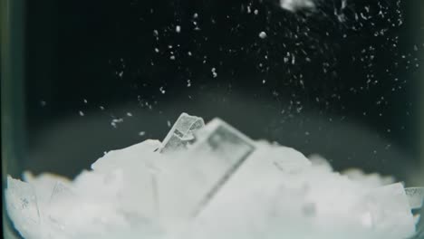 captivating close-up of ice crystals melting and fusing in water, showcasing unique textures and dynamic movement of frozen elements