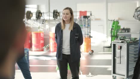 female manager discussing vehicle repair with mechanic in auto repair shop