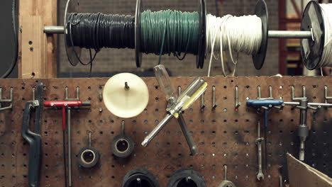 sliding shot of a worker's tool bench in a factory