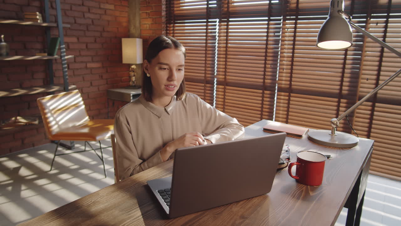 Positive Business Lady Web Conferencing on Laptop in Office