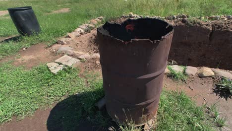 burning trash in old rusty barrel