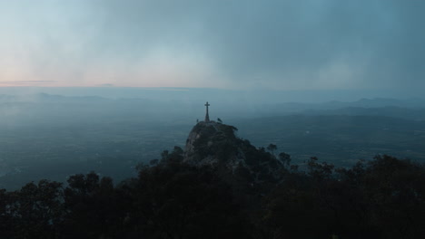 majestic cross atop hill in mallorca, spain. stunning panoramic landscape. perfect for spiritual or travel documentaries.