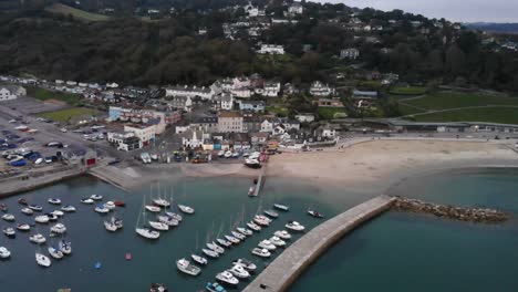 aerial panning left shot of lyme regis town and the cobb south west england at dawn