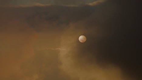 sun or moon obscured by hazy clouds