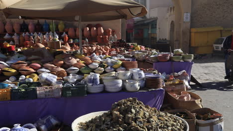 colorful ceramic dishes and pots displayed at a traditional market in tunisia under sunny skies