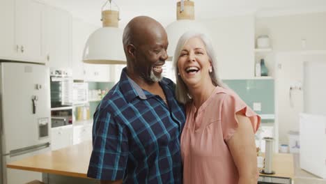 Portrait-of-happy-senior-diverse-couple-embracing