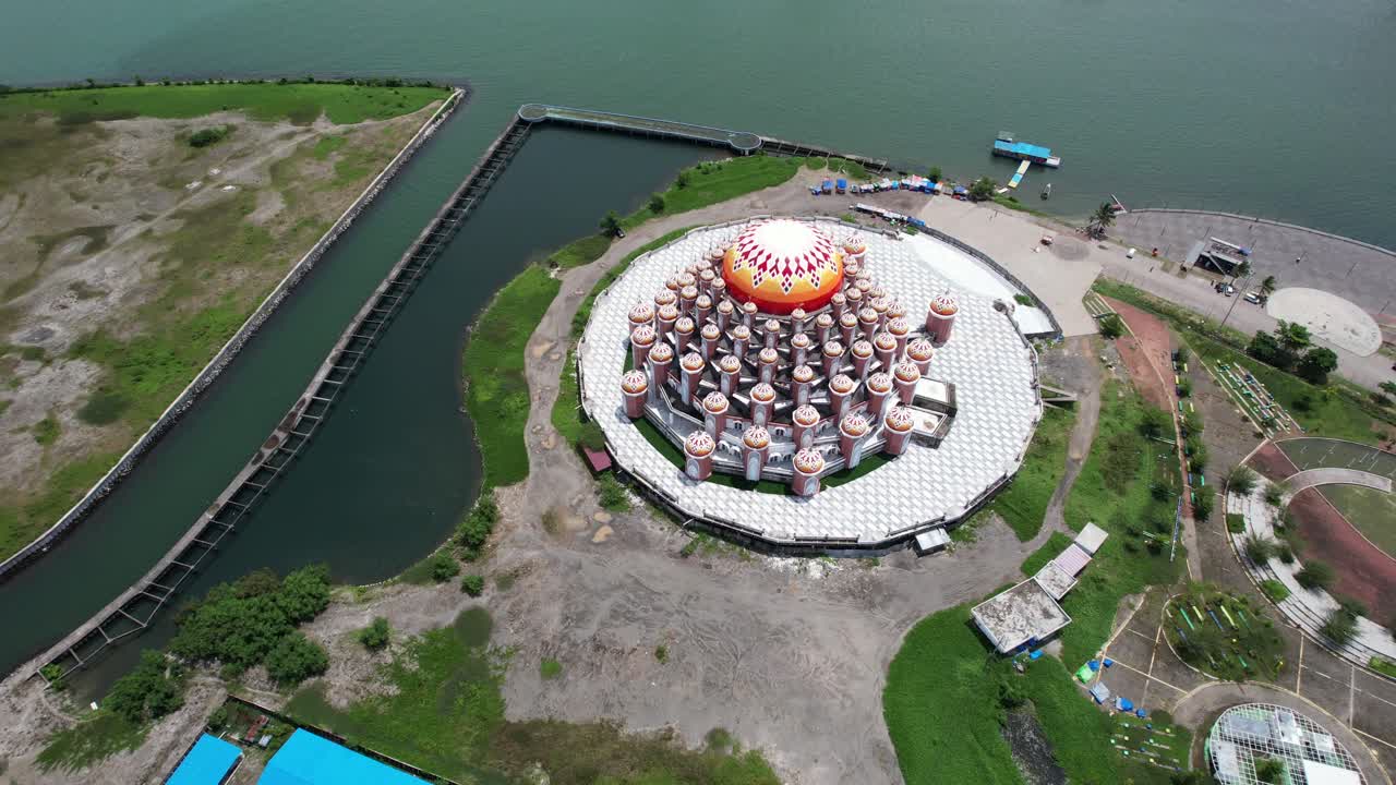 vista aérea de arriba hacia abajo de la mezquita de 99 cúpulas naranjas en la ciudad de makassar, sulawesi, indonesia, a lo largo del agua en un día soleado