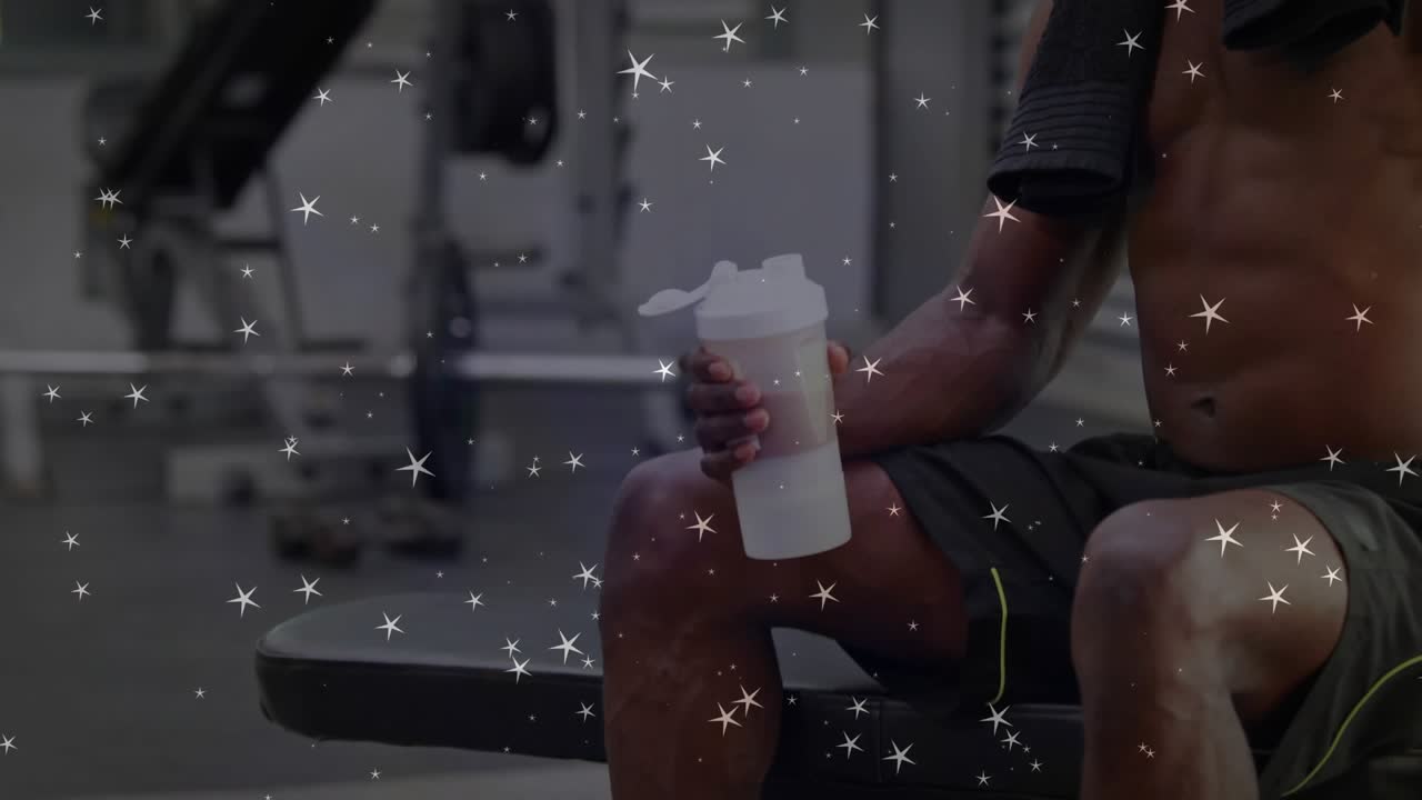 Man sitting bench lifting white shaker, drinking, camera zooming, stars overlaying for hydrating