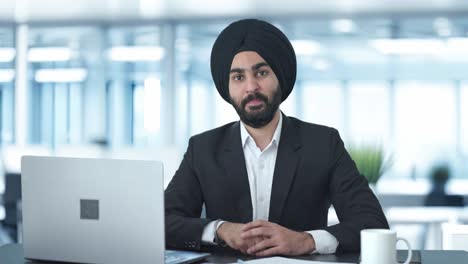 happy sikh indian businessman showing victory sign
