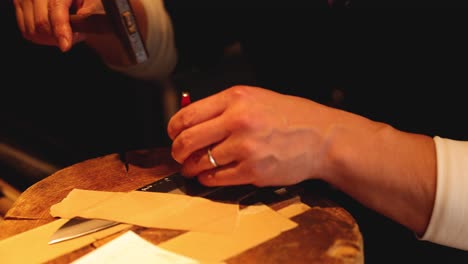 hands folding paper into an airplane