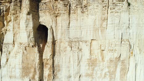 pale beige cliff face with cave