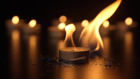 burning tea lights in the dark
