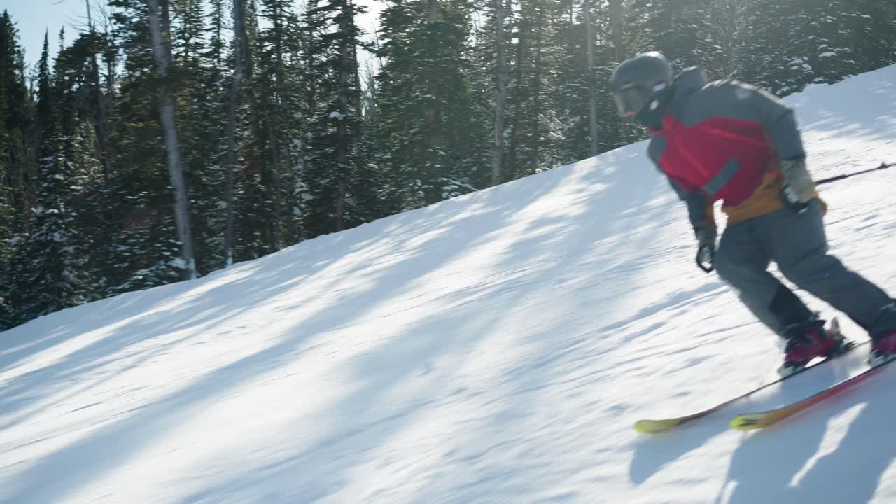 A skier on a nice day skiing fast on a groomed run in Big Sky Montana
