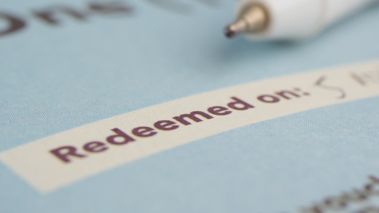 Writing Redemption Date on a Voucher with a Pen