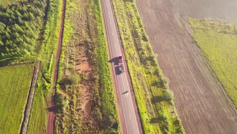 Empty-truck-and-motorbike-driving-on-countryside-road,-in-northern-Argentina,-South-America