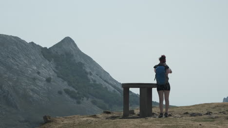 Fixed-Shot-Of-Woman-Standing-In-Front-Of-Stand-In-Virgin-Nature,-Looking-Through-Binocular,-Anboto-Vizcaya,-Basque-Country