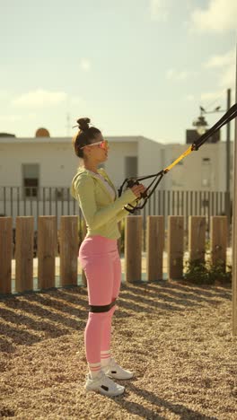woman working out outdoors with resistance bands