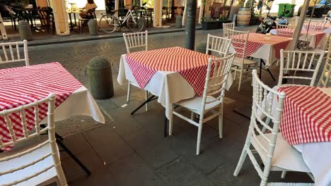 charming cafe tables with red checkered tablecloths