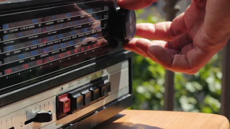 old retro am fm radio with tubes, hand changing stations , bulb vintage music player.