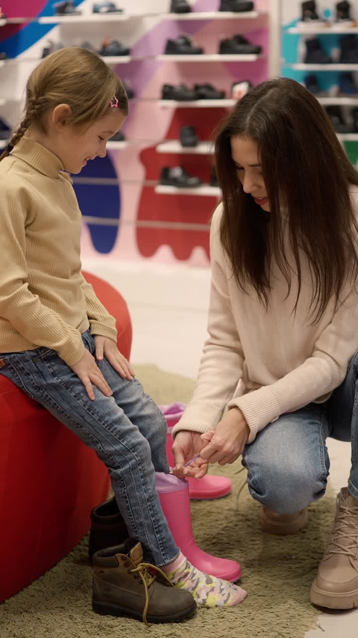 Mother and Daughter Trying on Rain Boots