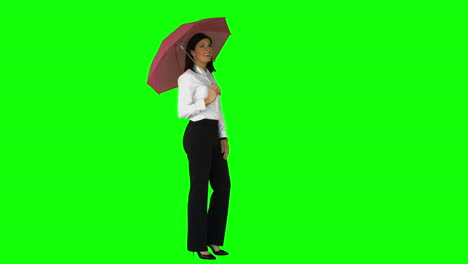 businesswoman wearing umbrella on green screen