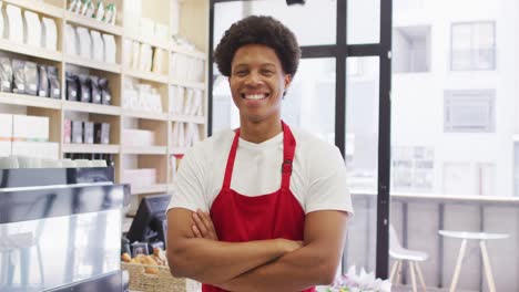 animation of happy biracial waiter standing in coffee shop