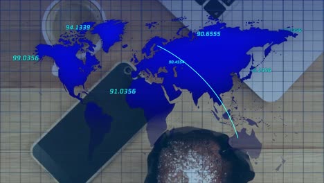 multiple numbers floating over world map over close up of a laptop, smartphone and coffee cup