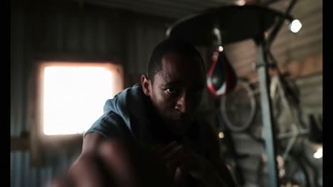 african american male boxer practicing boxing in fitness studio 4k