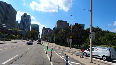 car pov riding through ottawa cityscape with modern skyscrapers and busy road