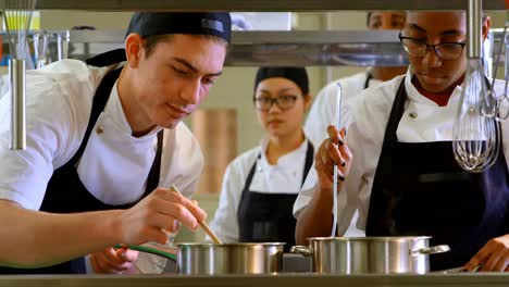 chef preparing food in kitchen at restaurant 4k