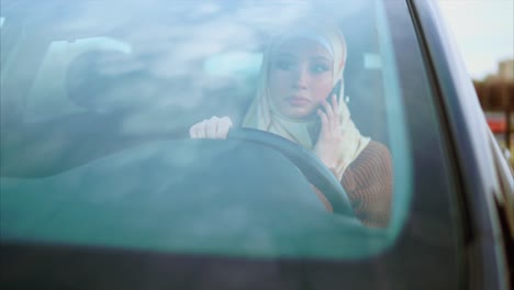 woman driving while talking on phone