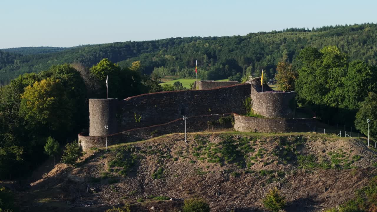 Scenic view of a castle on a hill surrounded by trees