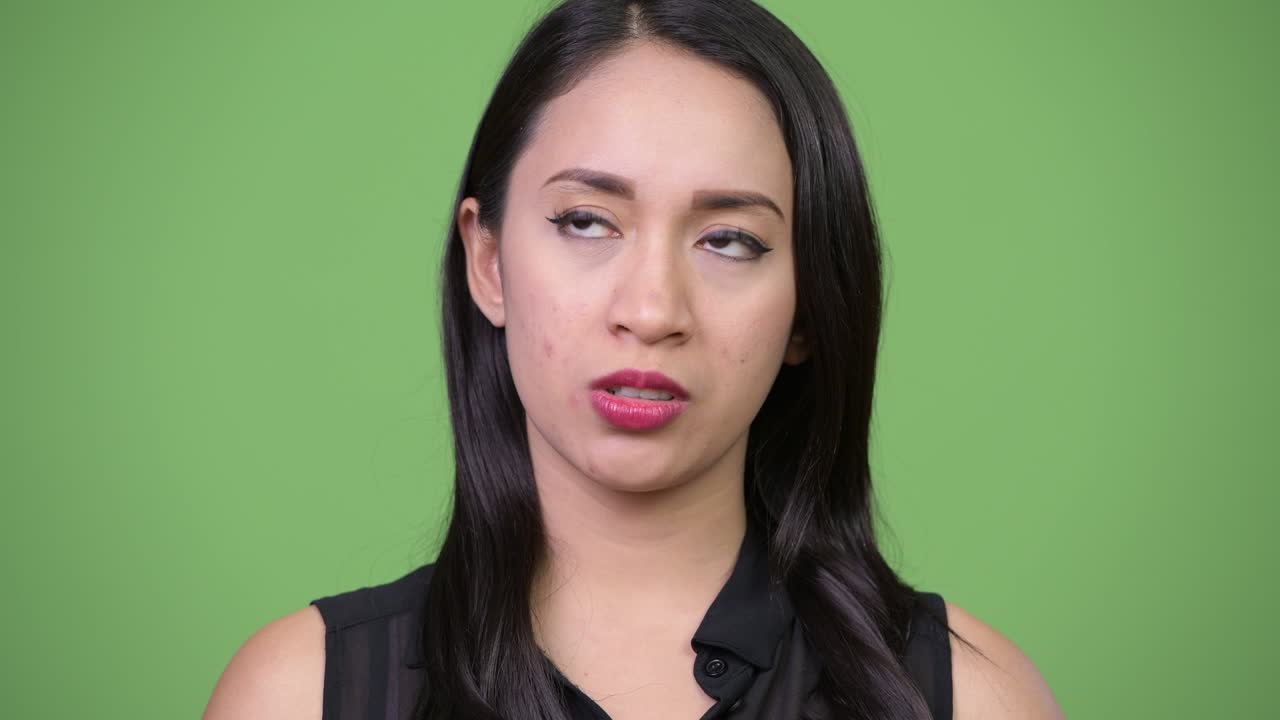 Young beautiful Asian businesswoman looking bored